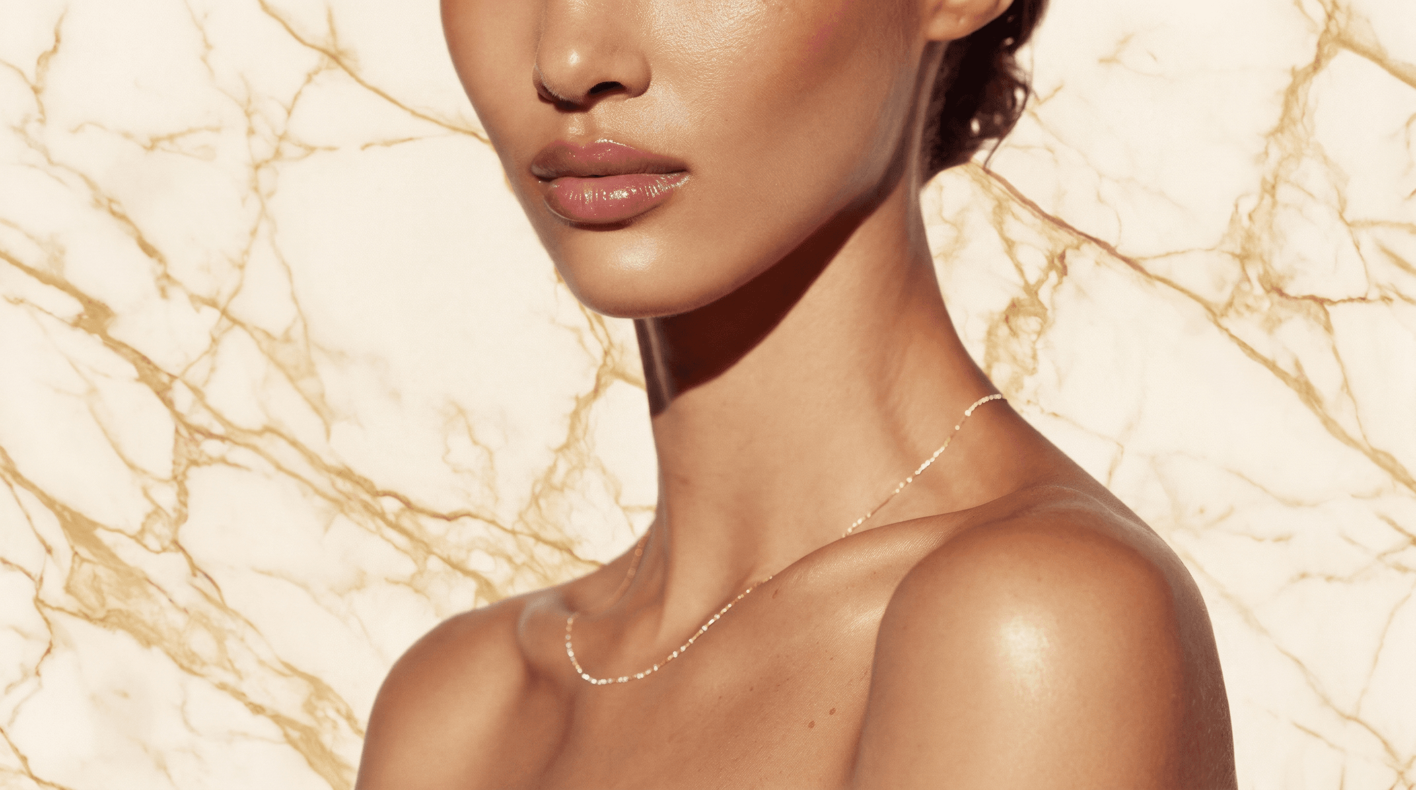 Botox and dermal fillers in Miami — natural lips and defined jawline, gold marble backdrop